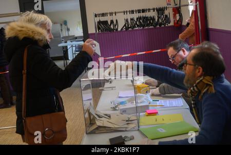 Foto aufgenommen in einem Wahllokal in Riaille (Loire-Atlantique, Frankreich) am 15. März 2020 während der ersten Runde der Kommunalwahlen, die trotz der Epidemie des Coronavirus / Covid-19 aufrechterhalten wurden. Wie überall in Frankreich wurden dort außergewöhnliche Maßnahmen ergriffen, um das Risiko einer Ausbreitung des Virus während der Abstimmung zu begrenzen: Bereitstellung von Wasserstellen und hydroalkoholischem Gel, mit Schutzhandschuhen ausgestattete Gutachter, Sicherheitsabstand von 1 Metern zwischen Personen, die durch Markierungen am Boden gekennzeichnet sind. (Foto von Estelle Ruiz/NurPhoto) Stockfoto