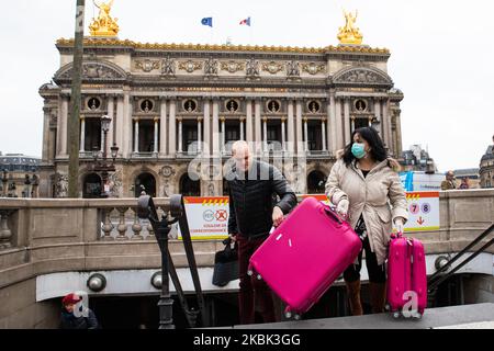 Touristen, die eine Gesichtsmaske tragen, besuchen am 16. März 2020 in Paris, Frankreich, Paris vor der Opera Garnier. Frankreich wartet heute Abend auf die Intervention ihres Präsidenten Emmanuel Macron über eine mögliche Eindämmung, Sperrung und Eindämmung der französischen Bevölkerung gegen die Ausbreitung des Coronavirus (COVID-19). Heute Morgen waren die Straßen in Paris fast leer, der Laden war geschlossen, wie die galleries Lafayette, Cartier, auf der Champs Elysees Avenue, und die Restaurants, als Fouquet's Restaurant. (Foto von Jerome Gilles/NurPhoto) Stockfoto