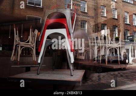 Am 21. März 2020 stehen Stühle an Tischen in einem geschlossenen italienischen Restaurant in der Monmouth Street im Londoner Stadtteil Seven Dials. Ein Großteil des Londoner Stadtzentrums war heute praktisch leer, einen Tag nachdem der britische Premierminister Boris Johnson die Schließung aller Pubs, Bars, Cafés und Restaurants im ganzen Land angeordnet hatte. Der Schritt stellt eine Verschärfung der Maßnahmen zur Durchsetzung der „sozialen Distanzierung“ dar, die den Bürgern dringend zur Verringerung des Wachstums von Covid-19-Coronavirus-Infektionen aufgezwungen wird. Nachtclubs, Theater, Kinos, Fitnessstudios und Freizeitzentren wurden ebenfalls geschlossen bestellt. Einige Geschäfte im Zentrum Stockfoto