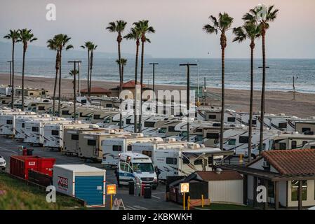 Am 1.. April 2020 kommt ein Krankenwagen auf einem Parkplatz am Strand an, der zusammen mit R.V's als Isolationszone für Menschen mit COVID-19 am Dockweiler State Beach in Los Angeles, Kalifornien, genutzt wird. Personen, die sich aufgrund von Obdachlosigkeit nicht selbst isolieren können oder in einem Haus mit hochgefährdeten Familienmitgliedern leben können, inmitten der Coronavirus-Pandemie, nutzen die Camper als sichere Zuflucht vor dem Virus. (Foto von John Fredricks/NurPhoto) Stockfoto