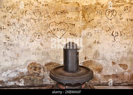 Graffiti zerkratzt in die Wand hinter einem Shiva Lingam am Brihadeeswarar Tempel (auch bekannt als Brihadisvara Tempel, Brihadishvara Tempel, Big Tempel, RajaRajeswara Tempel, Rajarajeswaram und Peruvudayar Tempel) ist ein Hindu-Tempel gewidmet Lord Shiva befindet sich in Thanjavur, Tamil Nadu, Indien. Der Tempel ist einer der größten Tempel in Indien und ist ein Beispiel für dravidische Architektur, die während der Chola-Zeit von Raja Raja Chola I erbaut und 1010 n. Chr. fertiggestellt wurde. Der Tempel ist über 1000 Jahre alt und ist Teil des UNESCO-Weltkulturerbes, das als "große lebende Chola-Tempel" bekannt ist Stockfoto