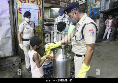 Die Eisenbahnschutztruppe (RPF) verteilt während einer Sperre in Kalkutta, Indien, am 17. April 2020 Freies Essen an Slum außerhalb des Bahnhofsgebiets. Der indische Premierminister Narendra Modi hat am Dienstag die weltweit größte Blockierung des Coronavirus verlängert, um den Höhepunkt der Epidemie zu erreichen, wobei Beamte rasten, um die verlorene Zeit aufzuholen. (Foto von Debajyoti Chakraborty/NurPhoto) Stockfoto