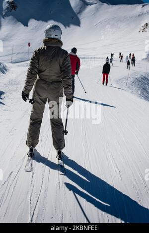 Skifahrer, die eine Skipiste in Frankreich, den Alpen, hinunterfahren Stockfoto