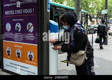 Am Montag, den 11. Mai 2020, in Paris, am ersten Tag der Aufhebung der Sperre der französischen Bevölkerung durch die 55 Tage andauernde Coronavirus-Pandemie COVID-19, wäscht eine junge Frau ihre Hände mit hydroalkoholischem Gel aus einem Gelspender, der an den RATP-Bushaltestellen installiert ist. Die Pariser kehren mit der Lockerung der sozialen Distanzierungsmaßnahmen und der Wiedereröffnung einiger Geschäfte auf die Straße und den öffentlichen Verkehr zurück. (Foto von Samuel Boivin/NurPhoto) Stockfoto