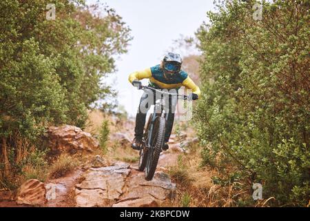 Fitness, Sport und Mann Radfahren in der Natur auf einem Fahrrad zum Training, Training und Bewegung im Freien allein. Fokussieren, gesund und schnell Sportler fährt ein Fahrrad Stockfoto