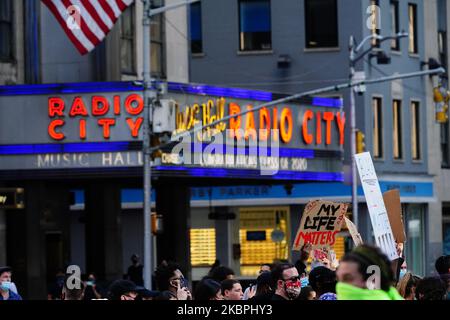 Demonstranten werden gesehen, wie sie an der Radio City Music Hall vorbeigehen, während sie sich am 31. Mai 2020 in New York City gegen den Tod des Minneapolis, Minnesota-Mannes George Floyd, in den Händen der Polizei versammelten. Floyds Tod wurde in einem Video festgehalten, das über den Vorfall viral wurde. (Foto von John Nacion/NurPhoto) Stockfoto