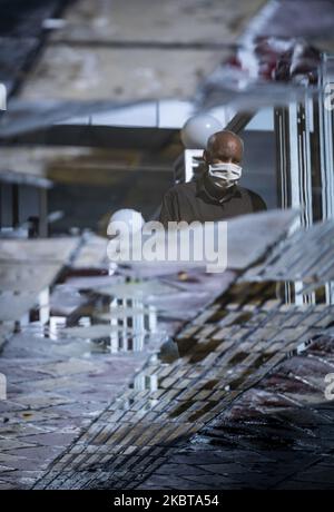 Ein älterer iranischer Mann mit Gesichtsmaske geht an einem regnerischen Tag im Zentrum von Teheran entlang einer Straße, nachdem am 3. Mai 2020 im Iran die neue Coronavirus-Krankheit (COVID-19) ausgebrochen war. Alle Bilder wurden vertikal gedreht. (Foto von Morteza Nikoubazl/NurPhoto) Stockfoto