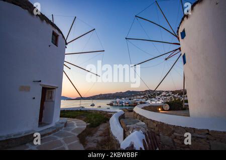 Magische Stunde bei Sonnenuntergang und Abenddämmerung in Little Venice auf Mykonos, einem der romantischsten Orte der Mittelmeerinsel am 14. Juli 2020. Dieses Viertel ist voll von eleganten und wunderschönen alten Häusern, die sich prekär am Rande der Ägäis befinden, farbenfrohe zweistöckige Gebäude im venezianischen Stil mit Holzbalkons. Diese Gebäude beherbergen heute trendige Bars, Restaurants, Galerien und mehr, aber ihr Äußeres ist immer noch einer der beliebtesten Sonnenuntergangsorte, das klassische romantische Mykonos-Erlebnis. Die berühmte Insel in den Kykladen wird als die Insel der Wi benannt Stockfoto