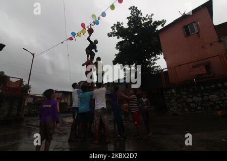 Eifrige Anhänger bilden eine menschliche Pyramide, um während des Hindu-Festivals von Janmashtami in Mumbai, Indien, am 12. August 2020 einen Tontopf zu brechen, der mit Quark gefüllt ist. Janmashtami wird als Geburtstag von lord Krishna, dem gott der Liebe und des Mitgefühls, gefeiert. (Foto von Himanshu Bhatt/NurPhoto) Stockfoto