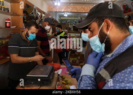Palästinenser versammeln sich in einem Geschäft während einer 48-stündigen Sperre, die nach der Entdeckung der ersten Coronavirus-Fälle im Gazastreifen am Dienstag, den 25. August 2020, verhängt wurde. (Foto von Majdi Fathi/NurPhoto) Stockfoto