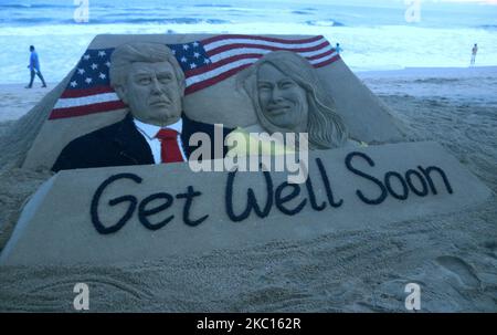 Die Sandskulptur von Donald Trump und seiner Frau Melania Trump wird am 04. Oktober mit ihrer Botschaft zur gesundheitlichen Erholung vom Sandkünstler Sudarshan Pattnaik am östlichen Küstenstrand der Bucht von Bengalen in Puri, 65 km von der Hauptstadt Bhubaneswar des östlichen indischen Staates Odisha entfernt, gesehen. 2020. (Foto von STR/NurPhoto) Stockfoto