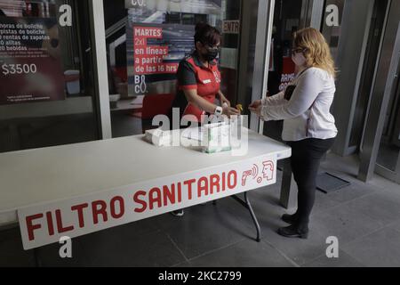 Das Personal des Bolerama Coyoacán Zentrums in Colonia Del Valle, Mexiko-Stadt, nimmt die Temperatur der Besucher auf und wendet während der Wiedereröffnung antibakterielles Gel an, nachdem es wegen des gesundheitlichen Notfalls aufgrund von COVID-19 in Mexiko für fast 8 Monate geschlossen wurde. Am 19. Oktober in Mexiko-Stadt, Mexiko. (Foto von Gerardo Vieyra/NurPhoto) Stockfoto