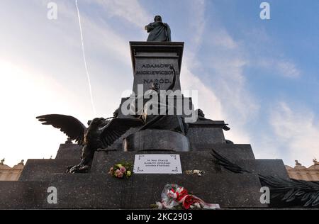 Ein Schild mit der Aufschrift „in der Nacht der Poesie dankt Krakau seinen Dichtern“, das am Fuße der Adam-Mickiewicz-Statue auf dem Marktplatz von Krakau zu sehen ist. Heute meldete das Gesundheitsministerium 9.291 neue Fälle von COVID-19 in Polen, darunter eine Rekordzahl von 1.486 in der Woiwodschaft Malopolskie. Außerdem lebt jede dritte Person, die in der Woiwodschaft Malopolskie mit COVID-19 diagnostiziert wurde, in Krakau. Am Dienstag, den 20. Oktober 2020, in Krakau, Polen. (Foto von Artur Widak/NurPhoto) Stockfoto