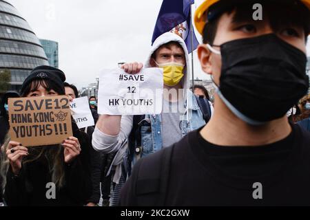 Pro-demokratische Aktivisten nehmen am 24. Oktober 2020 an einer Kundgebung zum Thema "Save 12 HK Jugend" Teil, bei der das prominente Exil von Hongkong, Nathan Law, im Potters Fields Park neben der Tower Bridge in London, England, teilnimmt. Die Kampagne „Save 12 HK Youngers“ fordert die Freilassung von 12 jungen pro-demokratischen Aktivisten, die seit August auf dem chinesischen Festland abgehalten wurden, nachdem sie beim Versuch erwischt wurden, mit dem Boot aus Hongkong zu fliehen, angeblich nach Taiwan. Die heutige Kundgebung in London markiert den ersten öffentlichen Auftritt von Law seit seiner Flucht nach Großbritannien im Juli nach der Einführung des in Hongkong von China verhängten Sicherheitsgesetzes, von dem Aktivisten sagen, dass es die Stadt aushöhlt Stockfoto