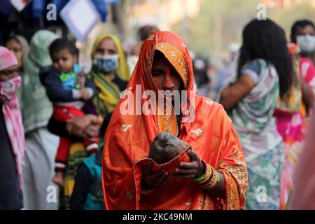 Eine hinduistische Frau, die Rituale durchführt und den sonnengott an einem künstlichen Teich anbetet, der auf der Straße oder auf dem Dach während des Chhath Puja Festivals in Neu Delhi am 20. November 2020 geschaffen wurde. Die Regierung von Delhi hat Gemeindefeiern von Chhath Puja an Flussufern, Ghats und Tempeln unter einer zunehmenden Anzahl von COVID-19-Fällen verboten. (Foto von Mayank Makhija/NurPhoto) Stockfoto