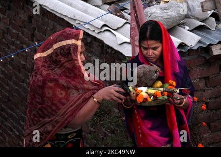 Eine hinduistische Frau, die Rituale durchführt und den sonnengott an einem künstlichen Teich anbetet, der auf der Straße oder auf dem Dach während des Chhath Puja Festivals in Neu Delhi am 20. November 2020 geschaffen wurde. Die Regierung von Delhi hat Gemeindefeiern von Chhath Puja an Flussufern, Ghats und Tempeln unter einer zunehmenden Anzahl von COVID-19-Fällen verboten. (Foto von Mayank Makhija/NurPhoto) Stockfoto