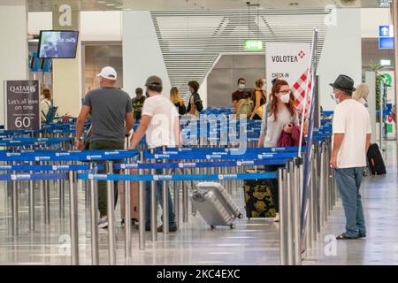 Passagiere, die mit den obligatorischen Gesichtsmasken in der Hauptabflugshalle im Terminal des internationalen Flughafens Athen ATH LGAV in Griechenland gesehen werden. In vielen Ländern Griechenlands wurden unter anderem Coronavirus-Maßnahmen wie Sperrung, Quarantäne und Reisebeschränkungen eingeführt. Passagiere, die Gesichtsmasken und Handschuhe tragen und Handdesinfektionsmittel als vorbeugende Maßnahme gegen die Ausbreitung der COVID-19-Pandemie verwenden. Griechenland und Europa schlossen die Grenzen für Menschen außerhalb Europas und der Schengen-Zone für eine lange Zeit, aber Griechenland begann mit der Aufhebung des Verkehrsverbots seit Juni 2020, um den Wirtschafts-, Reise- und Fremdenverkehr anzukurbeln Stockfoto