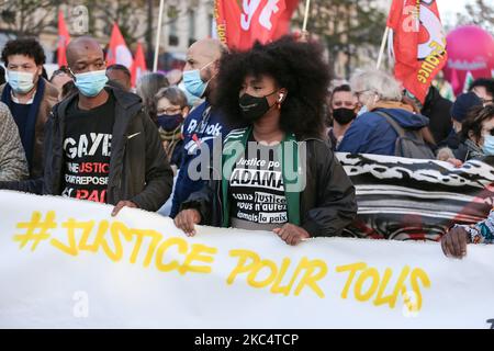 ASSA Traore (C), die Schwester des verstorbenen Adama Traore, eines Mannes, der in Polizeigewahrsam starb, steht am 28. November 2020 auf dem Place de la Republique in Paris während einer Demonstration gegen den Gesetzesentwurf zur "globalen Sicherheit", Artikel 24 würde die Veröffentlichung von Bildern diensthabender Polizeibeamter mit der Absicht kriminalisieren, ihre „körperliche oder psychische Integrität“ zu schädigen. Dutzende von Kundgebungen sind am 28. November gegen ein neues französisches Gesetz geplant, das den Austausch von Polizeibildern einschränken würde, nur wenige Tage nachdem das Land von Aufnahmen erschüttert wurde, die Polizisten schlugen und rac zeigten Stockfoto