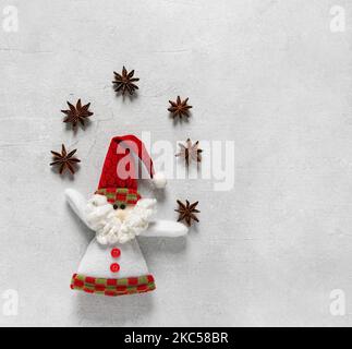 Weihnachtsmann und Weihnachtssterne Anis auf betontem Hintergrund, Draufsicht, Kopie s Stockfoto