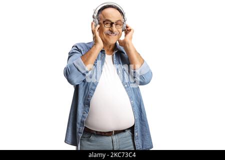 Fröhlicher, reifer Mann mit Kopfhörern, der auf weißem Hintergrund isolierte Musik hört Stockfoto