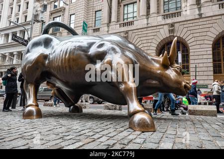 Die Bronze-Skulptur Charging Bull, auch bekannt als Wall Street Bull oder Bowling Green Bull in New York City, mit Touristen, die Fotos von ihr machen, da sie ein Wahrzeichen, ein Touristenziel ist, Eine beliebte Attraktion und Symbol für Wall Street und Financial District sowie mit aggressivem finanziellen Optimismus und Wohlstand, Reichtum und Glück, befindet sich am Broadway im Financial District von Manhattan. Es wurde von Arturo Di Modica im Jahr 1989 geschaffen. New York, USA am 2019. November (Foto von Nicolas Economou/NurPhoto) Stockfoto