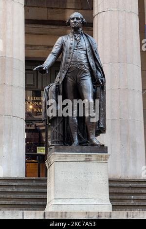 Eine Bronzestatue des ersten Präsidenten der Vereinigten Staaten von Amerika, George Washington, überblickt die Wall Street und die New York Stock Exchange NYSE von der Federal Hall, der ersten Hauptstadt, in New York City. George Washington wurde hier 1789 als Präsident eingeweiht, als NYC die Hauptstadt der Vereinigten Staaten war, bevor es 1790 nach Philadelphia, Pennsylvania, verlegt wurde. Installiert auf den vorderen Stufen des Federal Hall National Memorial an der Wall Street in New York City mit der Inschrift an der Basis der Skulptur GEORGE WASHINGTON GEBOREN 22. FEBRUAR 1732 WAKEFIELD WE Stockfoto