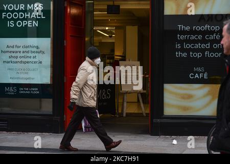 Ein Mann mit Gesichtsmaske kommt an einem Marks and Spencer-Laden in der Grafton Street in Dublin vorbei, der während der Covid-19-Sperre auf Level 5 gesehen wurde. Am Freitag, den 15. Januar 2021, in Dublin, Irland. (Foto von Artur Widak/NurPhoto) Stockfoto