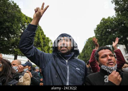 Ein Protestler setzt ein Siegeszeichen, als er während einer Demonstration in der Hauptstadt Tunis regierungsfeindliche Parolen singt, um zum Sturz des Regimes zu rufen und gegen die „Polizeigewalt“ zu protestieren, die bei den letzten nächtlichen Protesten im Land eingesetzt wurde. Demonstranten protestierten auch gegen die Erklärung des Präsidenten des Shura-Rates der islamistischen Ennahdha-Partei Tunesiens, Abdelkarim Harouni, der sagte: „Die Kinder von Ennahdha werden vor Ort sein, um die Sicherheitskräfte zu unterstützen“. Demonstranten skandierten Slogans, einige von ihnen hatten den Aufstand gegen die Autorita markiert Stockfoto
