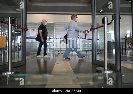 Passagiere mit Gesichtsmasken, Gesichtsschutz, Handschuhen und anderen Sicherheitsmaßnahmen werden vor dem Abflug am internationalen Flughafen Thessaloniki Makedonia SKG LGTS während der Ära der Coronavirus-Pandemie Covid-19 im Flughafenterminal gesehen. Es kommt eine zweite Welle, während die Fälle zunehmen, Gesichtsmask obligatorisch wird, soziale Distanzierungsmaßnahmen und Desinfektionsmittel überall sind, während neue Sperren oder Mini-Lockdown, Verkehrsverbot, Reisebeschränkungen oder Ausgangssperre von Regierungen auferlegt werden. Die Verwendung eines Facemask- und eines PCR-Negativtests sowie eines mehrfachen Schnelltests ist erforderlich Stockfoto