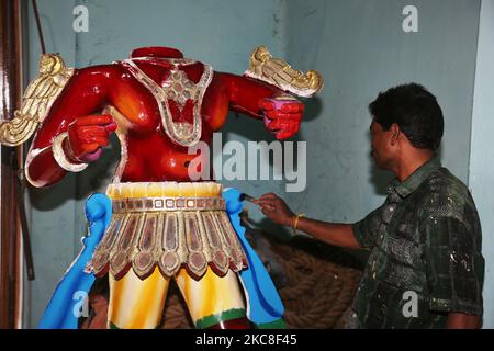 Artisan malt eine große Figur des Dämons Sooran am Arasadi Vinayagar Tempel (Arasadi Sithion Vinayagar Kovil) in Jaffna, Sri Lanka. Die Figur wird in der kommenden Sooran Por Festival verwendet werden (auch als Sooran Poor, Sooran Porr, Soorasamharam, Surasamharam genannt) ist eine Nachstellung der Schlacht von Lord Murugan und Soorapathman. Der Legende nach besiegte Lord Murugan den Dämon Soorapathman (Sooran) und seine Armee mit der heiligen Vel (Lanze), die ihm von seiner Mutter gegeben wurde. Lord Murugan kämpfte sechs Tage lang, und am letzten Tag befreite er die Devas (Götter) von Asuras (Dämonen). Sooran Por ist Hel Stockfoto