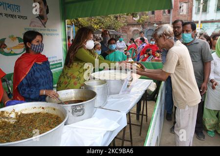 Schauspielerin und MLA Nayana Banerjee verteilen INR ..RS.5/ Mahlzeit nach der virtuellen Einweihung der westbengalen Chefministerin Mamata Banerjee am 15,2021. Februar in Kalkata. Vor den Parlamentswahlen im Bundesstaat hat die westbengalische Chefministerin Mamata Banerjee am Montag praktisch das „Maa“-Programm eingeführt, nach dem ihre Regierung den Armen eine Mahlzeit zu einem nominellen Preis von 5 Rs zur Verfügung stellen würde.Sie wird eine Platte Reis, Dal, Ein Gemüse- und Eierlikum für 5 Rs, sagte sie und fügte hinzu, dass die Landesregierung eine Subvention von 15 Rs pro Teller tragen werde.Selbsthilfegruppen werden die Küchen von 1 bis 3 Uhr bedienen Stockfoto