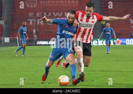 (L-R) Mathieu Valbuena #28 von Olympiacos und Nick Viergever #4 von PSV während der UEFA Europa League Runde des Spiels 32 zwischen PSV Eindhoven und Olympiakos Piräus am 25. Februar 2021 in Eindhoven, Niederlande. Während der UEFA Europa League Runde von 32 Spiel zwischen PSV Eindhoven und Olympiakos Piräus am 25. Februar 2021 in Eindhoven, Niederlande. (Foto von Nicolas Economou/NurPhoto) Stockfoto