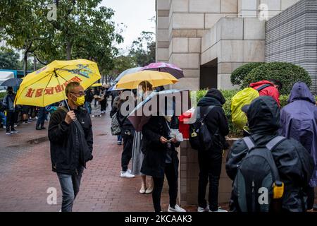 Während einer Anhörung von 47 Oppositionellen, die angeklagt sind, das nationale Sicherheitsgesetz der Stadt in Hongkong, China, am Mittwoch, den 4. März 2021 verletzt zu haben, halten Menschen Regenschirme hoch, während sie vor den Richtern von West-Kowloon warten. Dutzende von pro-demokratischen Aktivisten warten immer noch darauf, herauszufinden, ob sie aus dem Gefängnis befreit werden, bevor sie wegen Subversion-Anschuldigungen vor Gericht gestellt werden, während Peking die Pläne zur Überarbeitung des Wahlsystems der Finanzzentren vortreibt. (Foto von Vernon Yuen/NurPhoto) Stockfoto