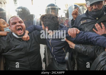 Während einer Demonstration vor dem Hauptquartier der tunesischen Zweigstelle der Internationalen Union für muslimische Gelehrte (IUMS) in der tunesischen Hauptstadt Tunis am 10. März 2021 chauffieren Demonstranten islamistischer Bewegungen mit Parolen, die mit Sicherheitskräften, die Schilde halten, zusammenlaufen. Aus Protest gegen den Präsidenten der Freien Destourien Partei (PDL), Abir Moussi und ihre Anhänger, die vor dem Hauptquartier der IUL ein Sit-in abhalten, um ihre Auflösung zu fordern. (Foto von Chedly Ben Ibrahim/NurPhoto) Stockfoto