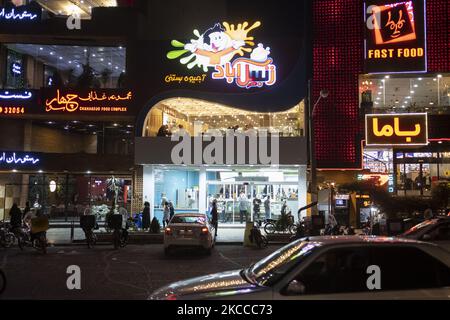 Blick auf eine Eisdiele und Fast-Food-Restaurants in der heiligen Stadt Qom, 145km (90 Meilen) südlich von Teheran in der Nacht inmitten des Ausbruchs der neuen Coronavirus-Krankheit (COVID-19) im Iran, 4. April 2021. Die Zahl der Todesfälle aufgrund des COVID-19, der in der Stadt Qom Null erreicht hatte, stieg am 4.. April erneut an. (Foto von Morteza Nikoubazl/NurPhoto) Stockfoto