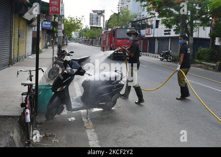 Beamte des State Disaster Response Fund (SDRF) und der Feuerwehr sprühen Desinfektionsmittel auf ein Fahrrad, um die Ausbreitung von COVID-19 im Bezirk Nagaon im nordöstlichen Bundesstaat Assam, Indien, am 2022021. Mai einzudämmen. (Foto von Anuwar Hazarika/NurPhoto) Stockfoto