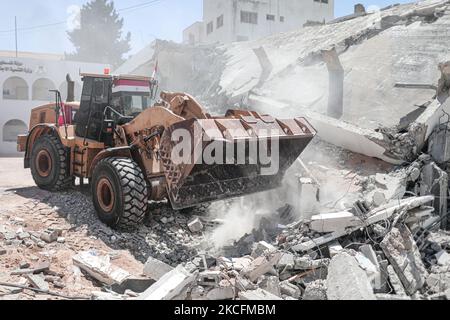 Ägyptische Arbeiter und Maschinen, die am 05. Juni 2021 die Trümmer der zerstörten Türme und Häuser in Gaza-Stadt abbauen. Ägypten gab am 04. Juni bekannt, dass es Arbeiter und Ausrüstung entsendet, um beim Wiederaufbau nach den Kämpfen zwischen Israel und Aktivisten im Gazastreifen zu helfen (Foto: Momen Faiz/NurPhoto) Stockfoto