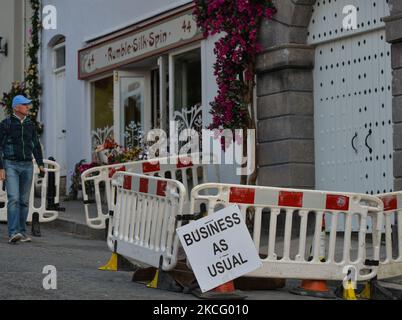 Ein Schild „Business as usual“, das außerhalb des Geschäftsgeländes im Dorf Enniskerry in der Grafschaft Wicklow zu sehen ist. Es sind nur noch zwei Tage, bis die Dreharbeiten für Disneys „enttäuschte“ Hauptrolle mit Amy Adams, Patrick Dempsey, James Marsden, Idina Menzel und Maya Rudolph beginnen. Ein Team von Zimmerleuten, Malern, Baumeistern und Dekorateuren hat den letzten Schliff gegeben, um Teile des Dorfes wie ein magisches Disney-Wunderland aussehen zu lassen. Am Freitag, den 11. Juni 2021, in Enniskerry, County Wicklow, Irland. (Foto von Artur Widak/NurPhoto) Stockfoto