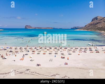 Luftaufnahme von einer Drohne des Balos Beach, die unglaubliche Lagune mit dem türkisfarbenen exotischen und tropischen Wasser des Mittelmeers befindet sich in der Region Chania auf der Insel Kreta. Balos ist einer der meistbesuchten Strände Kretas und beliebt bei Besuchern auf der ganzen Welt. Kristallklares Wasser, die Lagune, felsige steile Berge, eine Strandbar mit Sonnenschirmen und Schatten mit Getränken und eine Pirateninsel befinden sich in derselben Region, die mit einem 20-minütigen Trek oder Boot erreichbar ist. Griechenland versucht, seinen Tourismus anzukurbeln und Privilegien für Impfungen gegen die Coronavirus-Pandemie Covid-19 zu gewähren Stockfoto