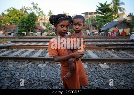 Baisakhi, 1 Jahre alt, mit ihrer älteren Schwester, die neben der Eisenbahnstrecke steht. Aufgrund von COVID-19 ist ihre Schule für eine lange Zeit geschlossen. Das gesamte Bildungssystem des Landes ist schwer getroffen, da Online-Medien nicht überall zugänglich sind.am 23. Juni 2021 in Kalkutta, Indien (Foto: Dipayan Bose/NurPhoto) Stockfoto