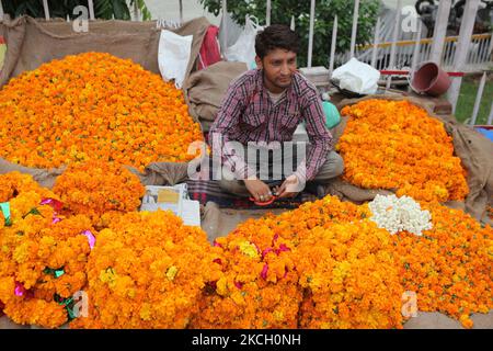 Mann, der am 30. Juni 2010 Girlanden aus Ringelblumen vor dem Shiva-Tempel in der Stadt Jammu, Indien, herstellte und verkaufte. (Foto von Creative Touch Imaging Ltd./NurPhoto) Stockfoto