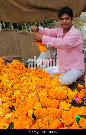 Mann, der am 30. Juni 2010 Girlanden aus Ringelblumen vor dem Shiva-Tempel in der Stadt Jammu, Indien, herstellte und verkaufte. (Foto von Creative Touch Imaging Ltd./NurPhoto) Stockfoto