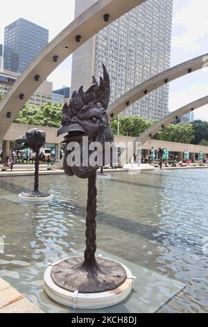 Die Bögen des Nathan Phillips Square, der den Pool reflektiert, schweben über den Statuen eines Hahns und eines Hundekopfes vor dem Alten Rathaus als Teil von Ai Weiweis Skulptur-Installation Circle of Animals (Chinese Zodiac) am 23. Juni 2013 in Toronto, Ontario, Kanada. (Foto von Creative Touch Imaging Ltd./NurPhoto) Stockfoto