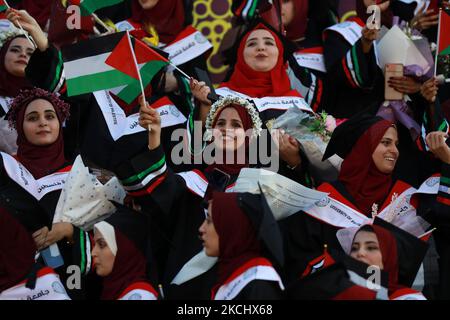 Palästinensische Studentinnen nehmen am 28. Juli 2021 an ihrer Abschlussfeier an der palästinensischen Universität in der Stadt Al-Zahra im Zentrum des Gazastreifens Teil. (Foto von Majdi Fathi/NurPhoto) Stockfoto