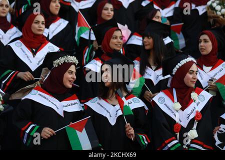 Palästinensische Studentinnen nehmen am 28. Juli 2021 an ihrer Abschlussfeier an der palästinensischen Universität in der Stadt Al-Zahra im Zentrum des Gazastreifens Teil. (Foto von Majdi Fathi/NurPhoto) Stockfoto