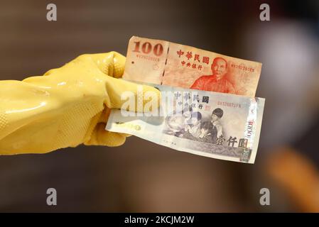 Arbeitnehmer mit einer nassen Marktanzahl und geben neue Taiwan-Dollar-Noten an Kunden zurück, da Taiwan während der covid-19-Pandemie in Taipei, Taiwan, am 15. August 2021, voraussichtlich ein positives BIP- und Wirtschaftswachstum aufweisen wird. Mit stärkeren Verbindungen bauen mit den USA und anderen europäischen und asiatischen Ländern einschließlich Litauen, Taiwan wird eine Zunahme des Handels, Investitionen, Exporte, die profitieren würde die countryâ €™s Wirtschaft. (Foto von Ceng Shou Yi/NurPhoto) Stockfoto