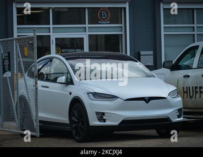 Tesla-Auto vor dem Bitcoin Solutions Cryptocurrency Center in Edmonton gesehen. Am Dienstag, den 17. August 2021, in Edmonton, Alberta, Kanada. (Foto von Artur Widak/NurPhoto) Stockfoto