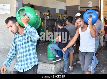 Am Dienstag, den 24. August 2021, stehen die Bewohner vor einer Tankstelle, um Gasflaschen in Beirut, Libanon, zu füllen. Die Treibstoffkrise in Beirut hat Stromausfälle verschärft und zu kilometerlangen Leitungen an Tankstellen während der schlimmsten finanziellen Kernschmelze Libanons in Erinnerung geführt (Foto: Fadel Itani/NurPhoto) Stockfoto