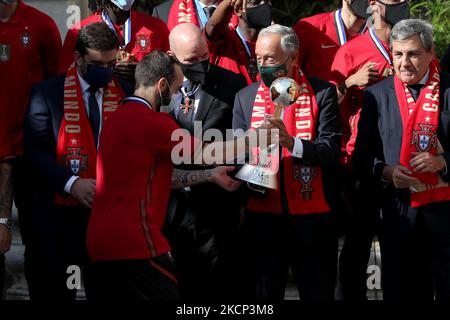 Der portugiesische Präsident Marcelo Rebelo de Sousa (C ) erhält am 4. Oktober 2021 im Belem-Palast in Lissabon, Portugal, die Trophäe der FIFA-Futsal-Weltmeisterschaft von Portugals Kapitän Ricardinho (L). Portugal gewann die Trophäe der FIFA Futsal-Weltmeisterschaft 2021, nachdem es Argentinien (2-1) am 03. Oktober in Kaunas, Litauen, besiegt hatte. (Foto von Pedro FiÃºza/NurPhoto) Stockfoto