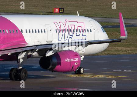 Wizz Air Airbus A321-Flugzeuge, wie sie während des Rollens, des Start- und der Flugphase vom Flughafen Eindhoven WÄHREND eines sonnigen Wintertages am blauen Himmel gesehen werden. W!ZZ Air ist ein ungarischer Ultra Low Cost Airline Carrier mit den größten Stützpunkten am Flughafen Budapest und am Flughafen Luton, der 164 Flughäfen anfliegt. Das Flugzeug A321-200 mit der Logo-Aufschrift auf der Seite hat die Registrierung HA-LXV. Die weltweite Luftfahrtindustrie versucht, sich von den negativen Auswirkungen der Coronavirus-Pandemie Covid-19 zu erholen. Eindhoven, Niederlande am 22. November 2021 (Foto: Nicolas Economou/NurPhoto) Stockfoto